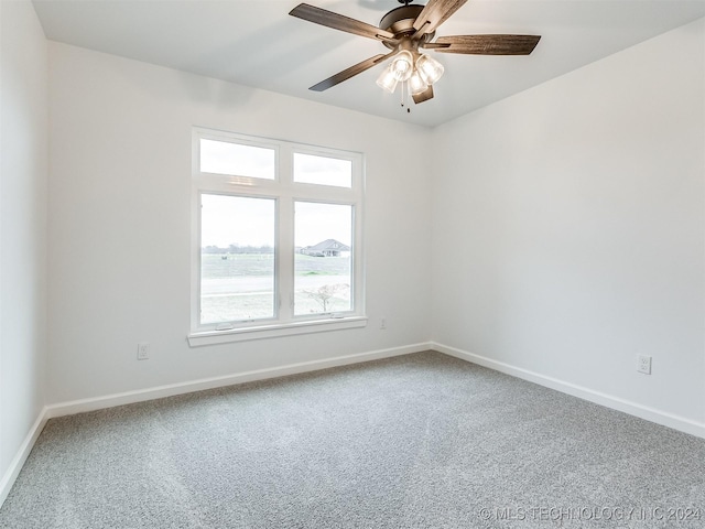 carpeted empty room featuring ceiling fan