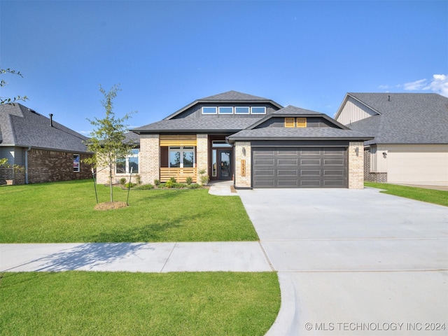 view of front of home with a garage and a front lawn