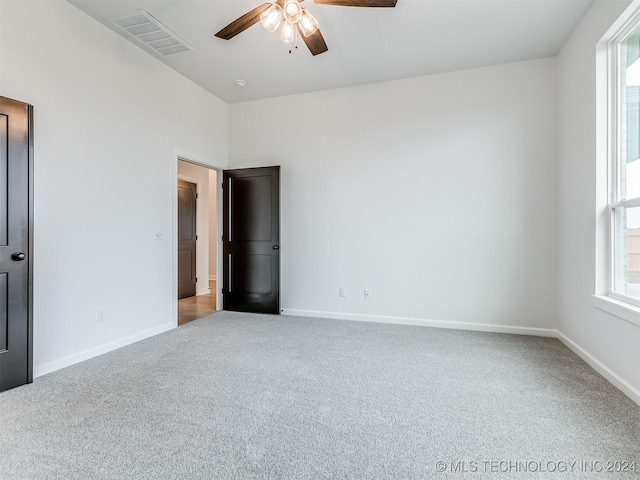 carpeted empty room with ceiling fan