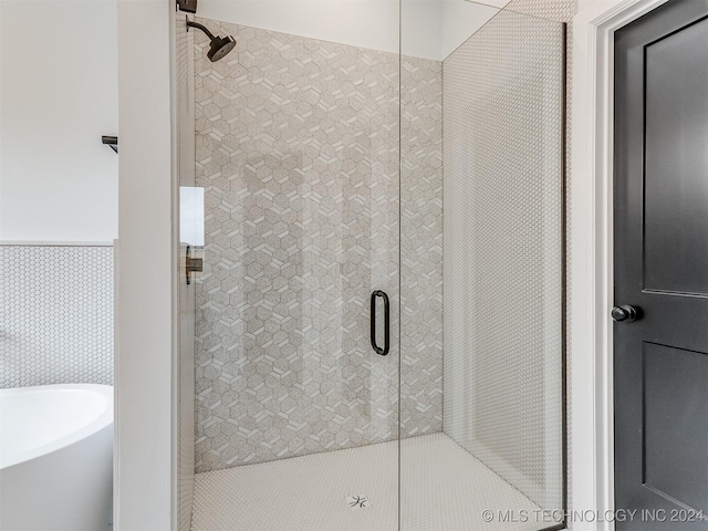 bathroom with shower with separate bathtub