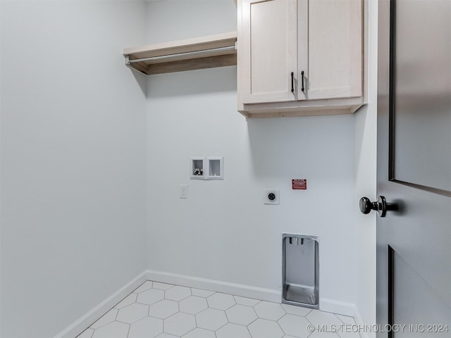 laundry room featuring hookup for an electric dryer, washer hookup, and cabinets