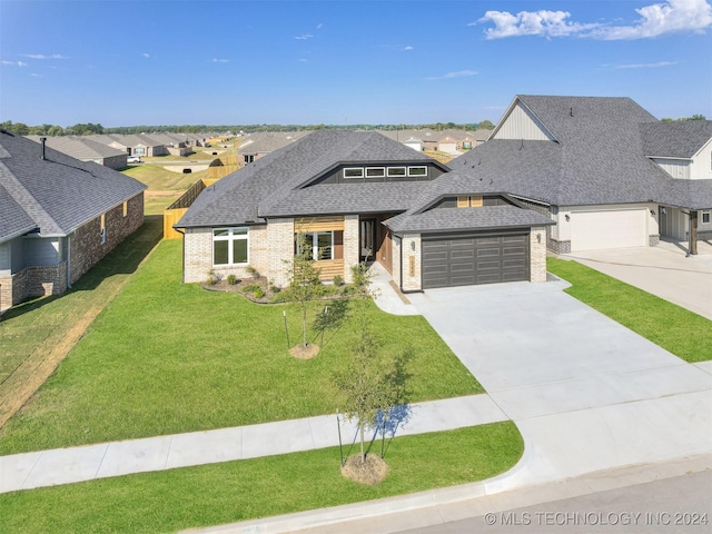 view of front of house featuring a garage and a front lawn