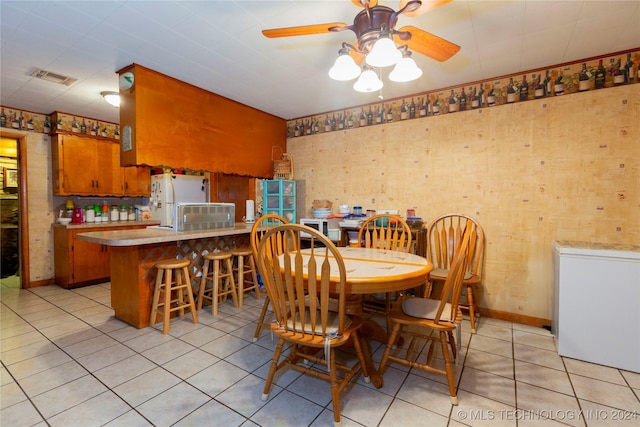 tiled dining room with ceiling fan