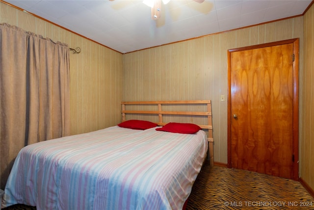 bedroom with carpet flooring, ceiling fan, and crown molding