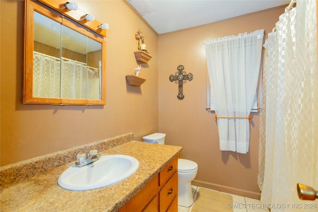 bathroom featuring toilet, vanity, and tile patterned floors