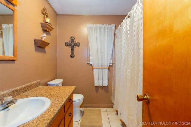 bathroom featuring tile patterned floors, vanity, and toilet