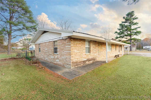 view of home's exterior with a yard