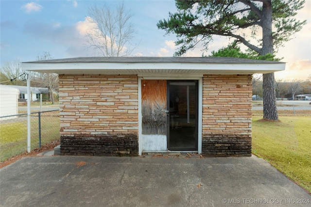 outdoor structure at dusk with a yard