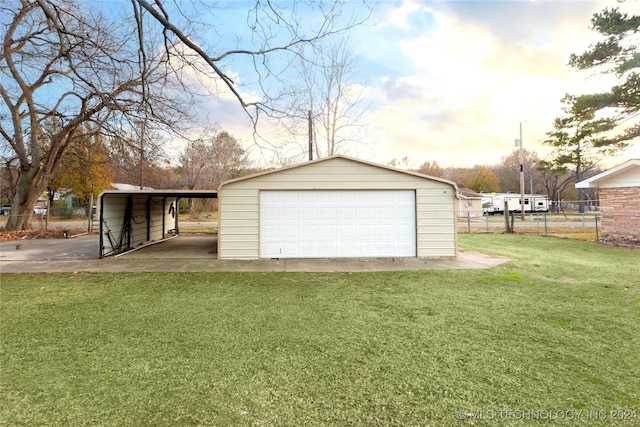 garage at dusk with a lawn and a carport