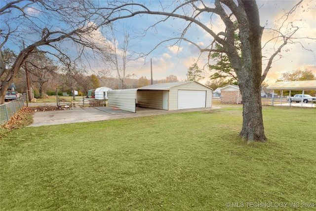 yard at dusk featuring an outdoor structure