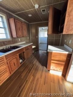 kitchen with wood-type flooring, sink, and wooden ceiling