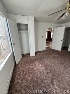 unfurnished bedroom featuring dark carpet and ceiling fan