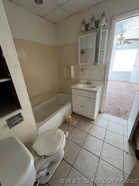 bathroom with tile patterned flooring, vanity, ceiling fan, and toilet