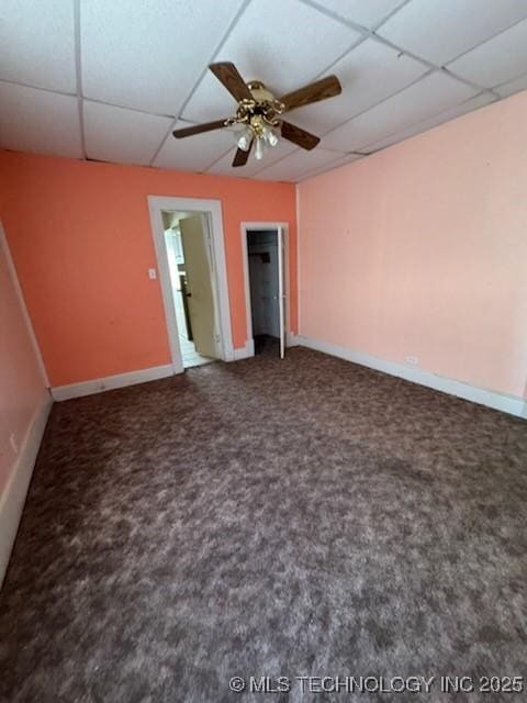 interior space featuring carpet floors, a paneled ceiling, and ceiling fan