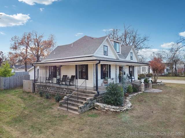 farmhouse-style home with covered porch and a front lawn