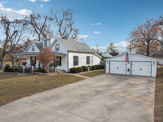 view of front of house featuring a porch, a front yard, an outdoor structure, and a garage