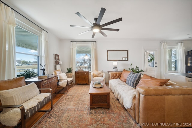 living room featuring hardwood / wood-style flooring, ceiling fan, and a healthy amount of sunlight