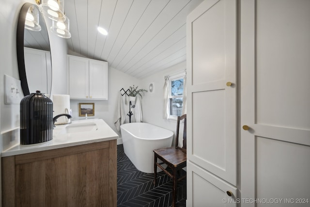 bathroom with a washtub and vanity