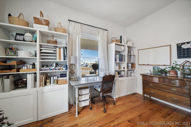 office space featuring hardwood / wood-style floors and vaulted ceiling