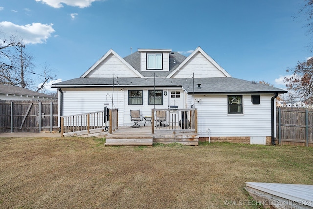 rear view of house featuring a yard and a deck