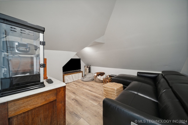 living room with lofted ceiling and light wood-type flooring