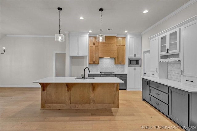 kitchen with sink, gray cabinets, a center island with sink, white cabinets, and light wood-type flooring