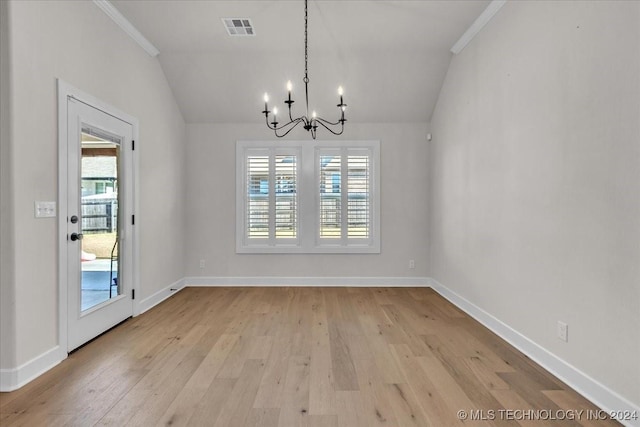 unfurnished dining area featuring light hardwood / wood-style floors, vaulted ceiling, and a healthy amount of sunlight