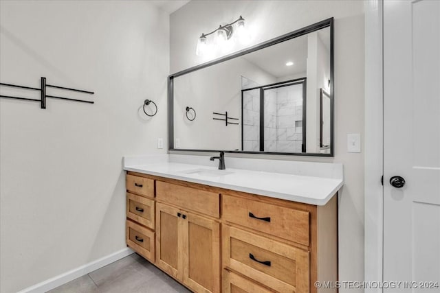 bathroom featuring tile patterned floors, vanity, and a shower with shower door