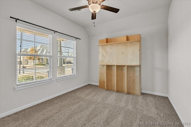 unfurnished bedroom featuring carpet, a closet, lofted ceiling, and ceiling fan