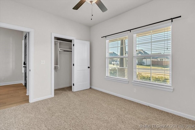 unfurnished bedroom with light colored carpet and ceiling fan