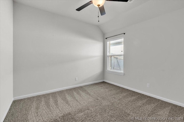 empty room featuring carpet flooring, ceiling fan, and vaulted ceiling