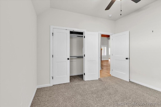 unfurnished bedroom with ceiling fan, lofted ceiling, and light carpet