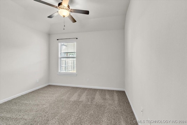 carpeted empty room with ceiling fan and lofted ceiling