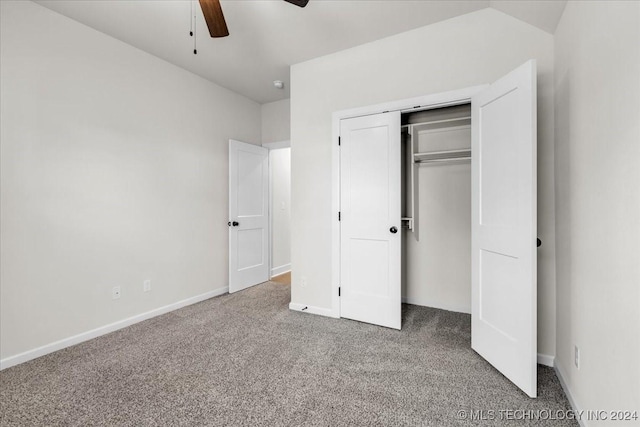 unfurnished bedroom featuring ceiling fan, a closet, and carpet