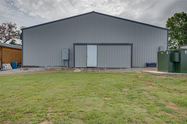 view of outbuilding featuring a lawn