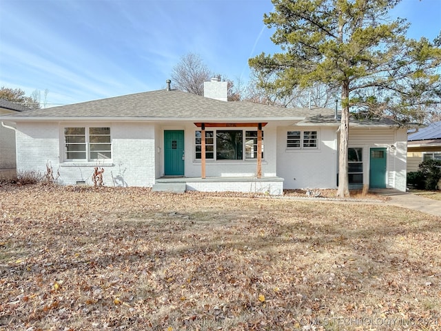 ranch-style house with covered porch and a front yard