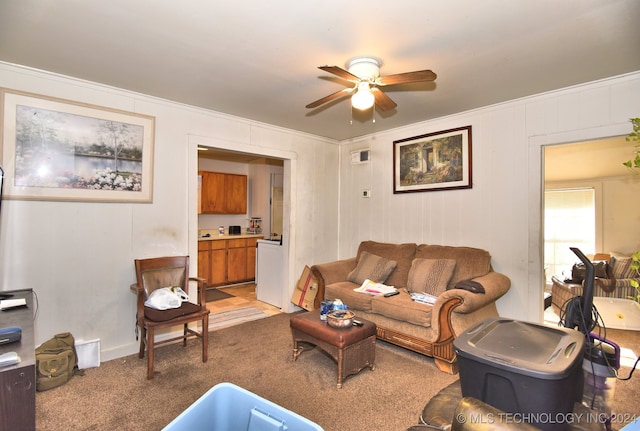 living room featuring ceiling fan, carpet floors, and ornamental molding