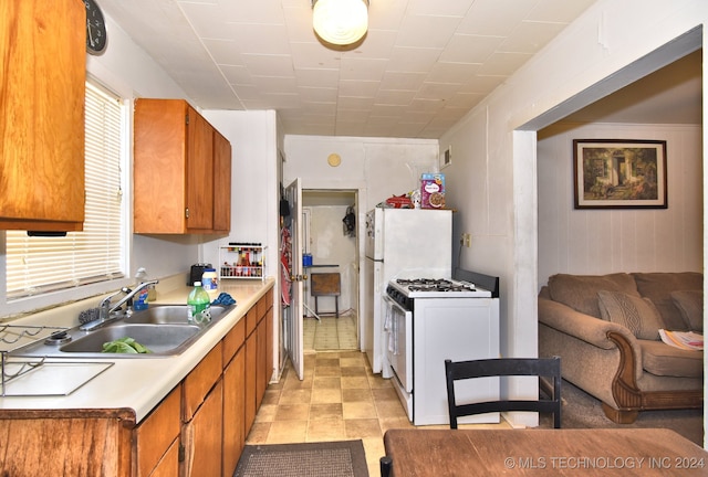 kitchen with white gas range oven and sink