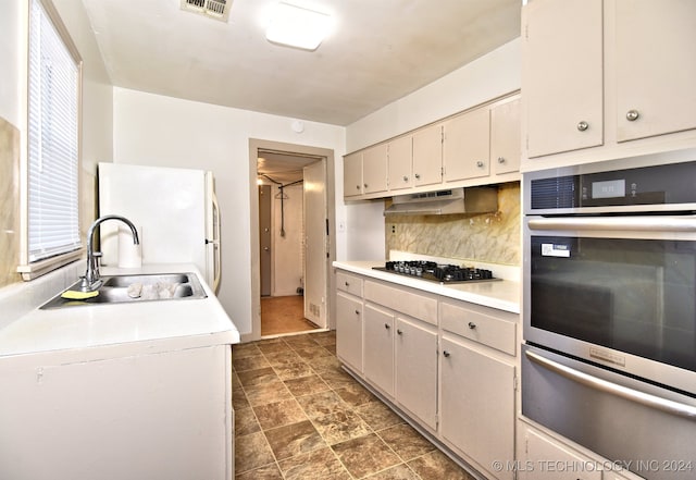 kitchen featuring backsplash, sink, and stainless steel appliances