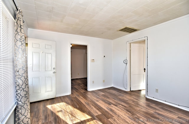 unfurnished room featuring crown molding and dark hardwood / wood-style flooring