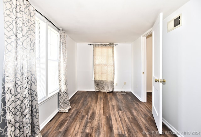 unfurnished room featuring dark hardwood / wood-style floors