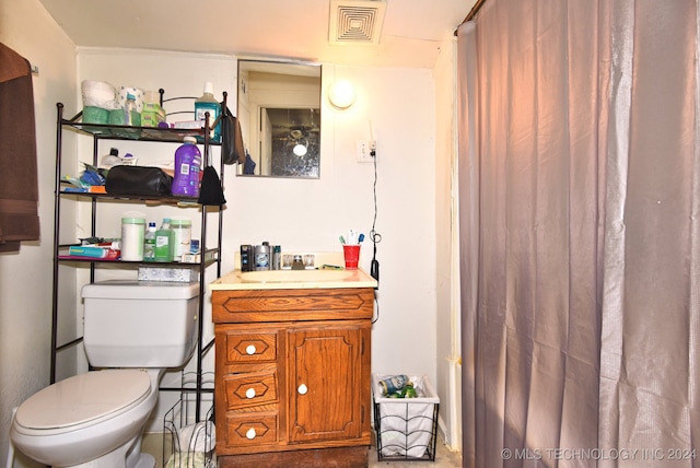 bathroom featuring vanity and toilet