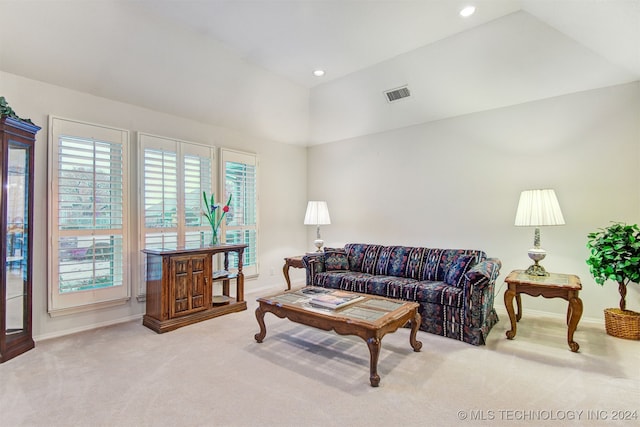 living room with light carpet and vaulted ceiling