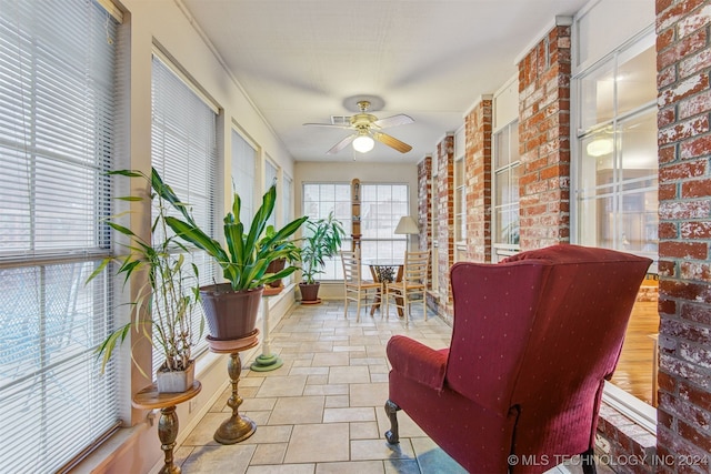 sunroom featuring ceiling fan