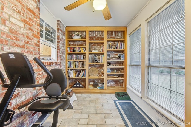 office with crown molding and brick wall