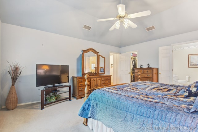 carpeted bedroom with vaulted ceiling, a closet, a spacious closet, and ceiling fan