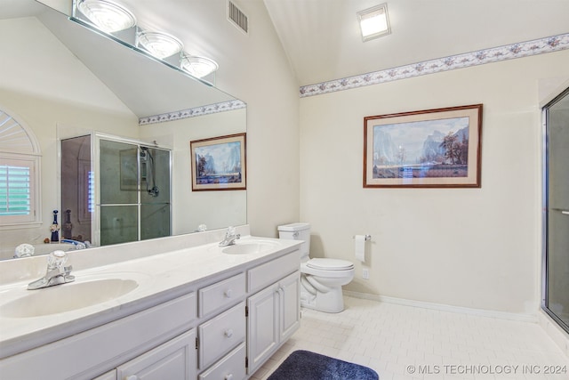 bathroom with tile patterned flooring, vanity, a shower with door, and vaulted ceiling