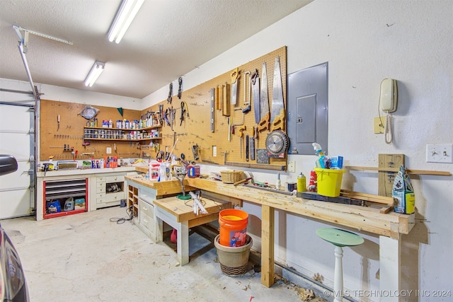 garage featuring a workshop area and electric panel