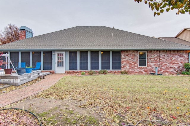 rear view of house with a lawn