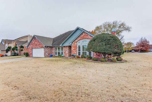 front of property featuring a front yard and a garage